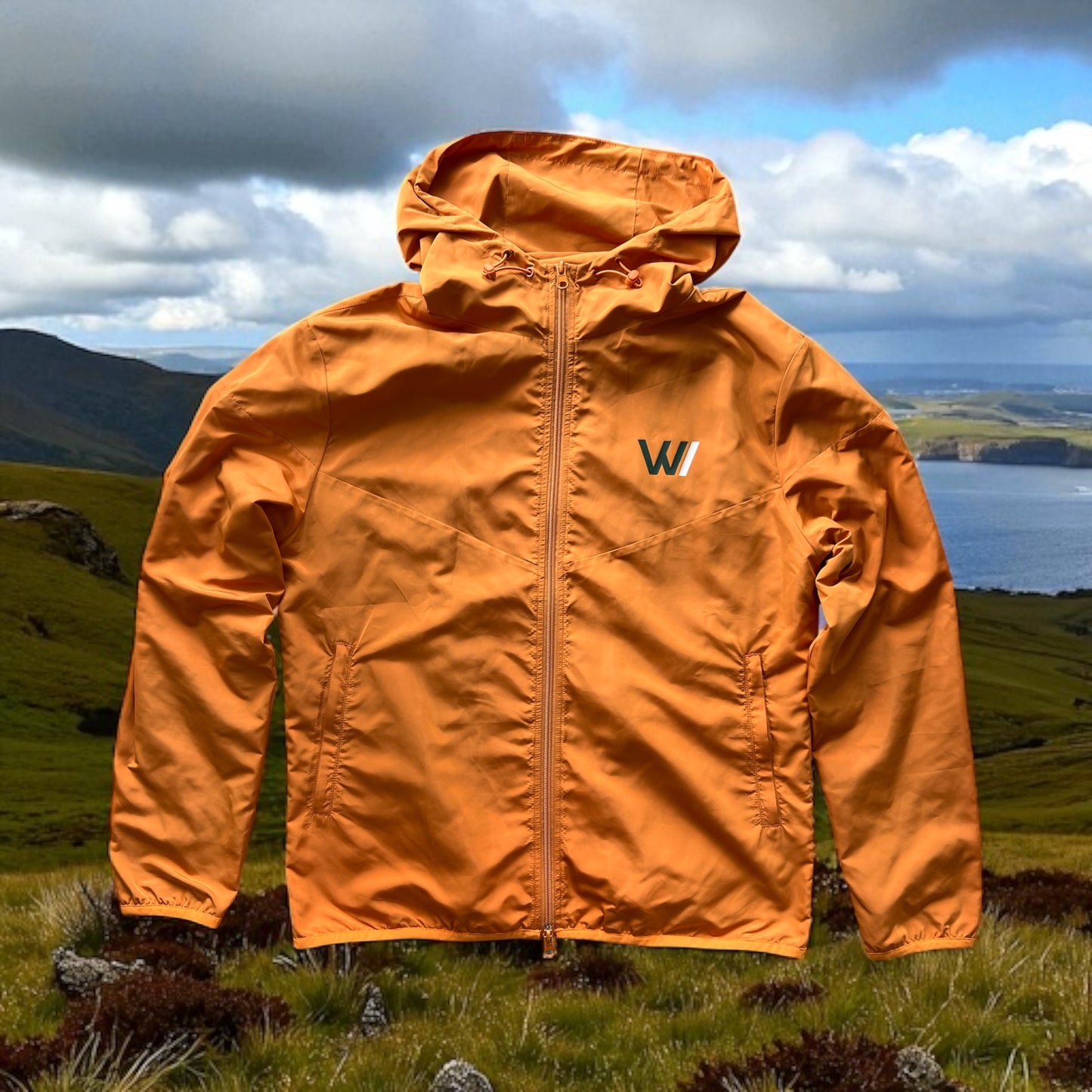 W/end Windbreaker Hot Ember Jacket with a logo on a mountainous landscape